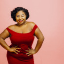 Confident in my body / Portrait of a happy, curvy young woman in red dress