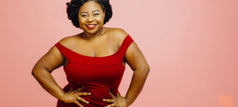 Confident in my body / Portrait of a happy, curvy young woman in red dress