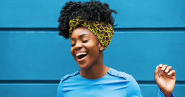 Joyous woman infront of wall
