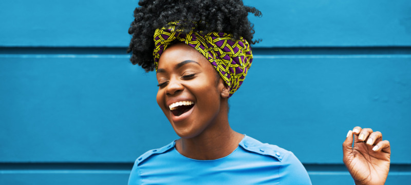 Joyous woman infront of wall