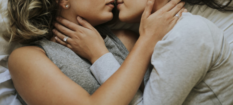 Lesbian couple kissing in the morning