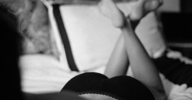 Woman in lingerie laying on bed