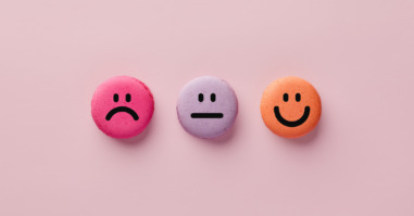 Colorful macarons with happy, neutral and sad faces. Customer rating and evaluation.
