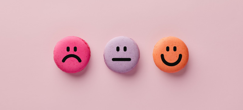 Colorful macarons with happy, neutral and sad faces. Customer rating and evaluation.