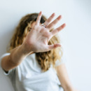 Portrait of Woman covering her face with her hand