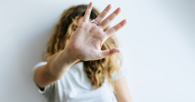 Portrait of Woman covering her face with her hand