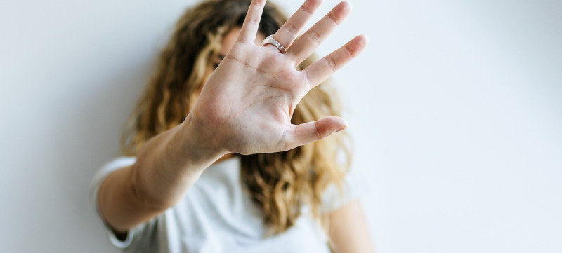 Portrait of Woman covering her face with her hand