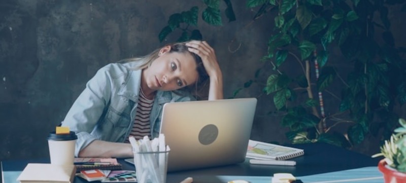 vermoeide vrouw achter laptop