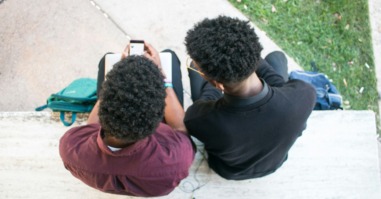 twee jongeren zitten op hun smartphone