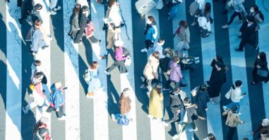 mensen lopen haastig over een zebrapad