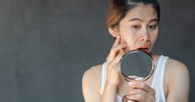 Vrouw kijkt in de spiegel met angst