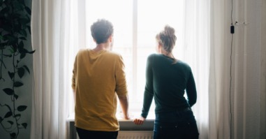 partners staan voor het raam en bespreken hun politieke voorkeur