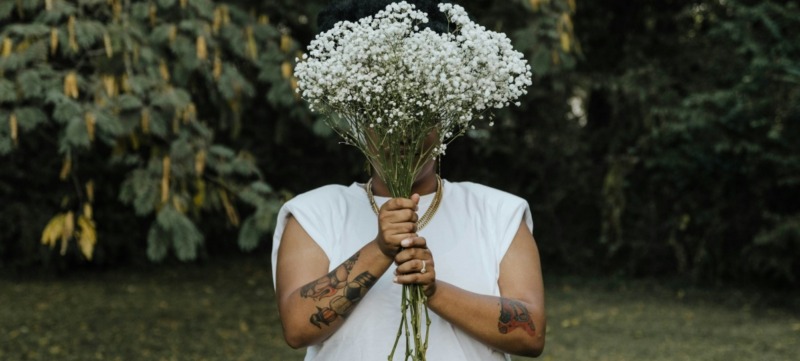 vrouw houdt een bos bloemen vast voor zichzelf
