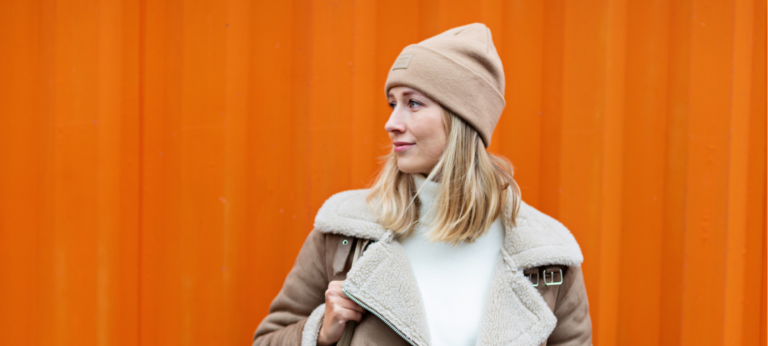 vrouw met een warme muts als illustratie bij een artikel over de winterdip
